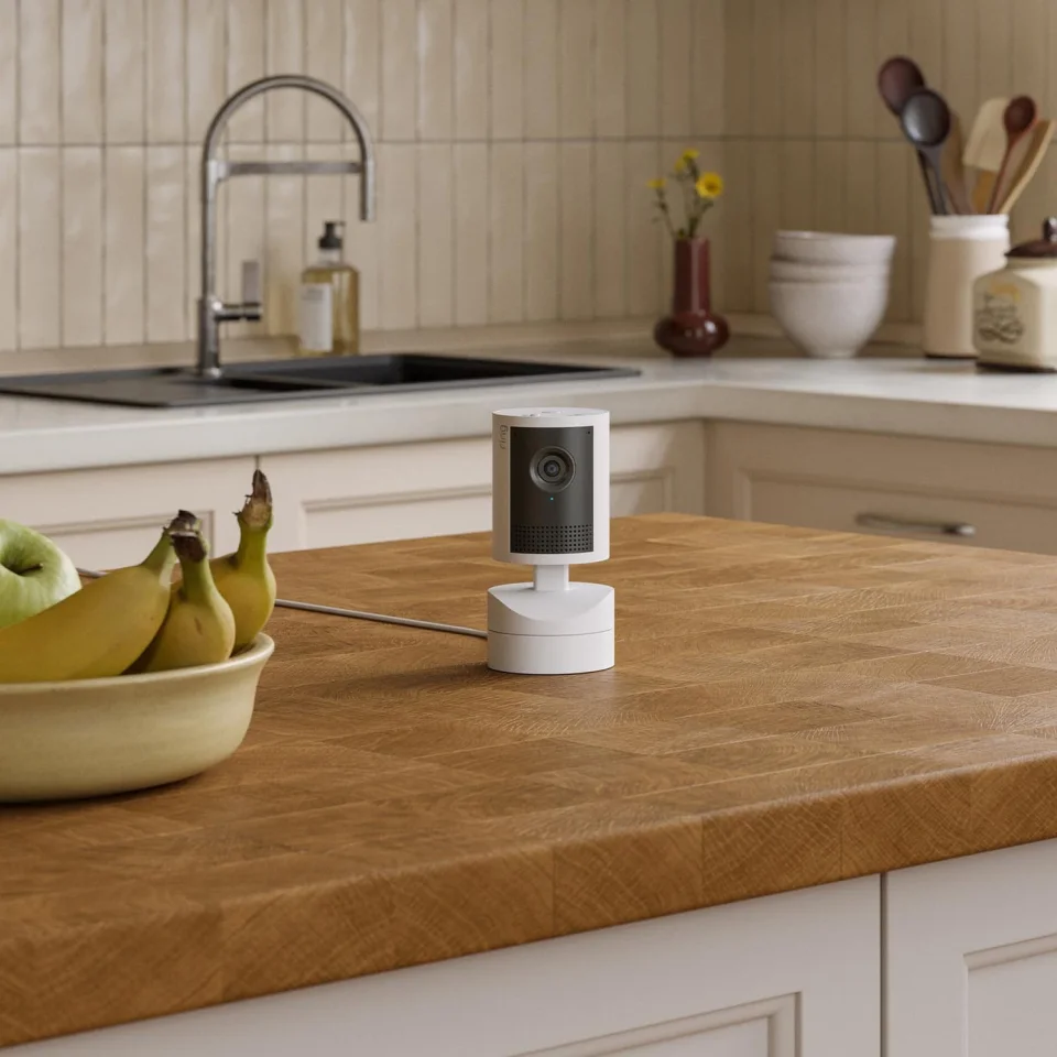 Ring Pan-Tilt Indoor Cam 2K on a kitchen counter, set back from the sink and stove
