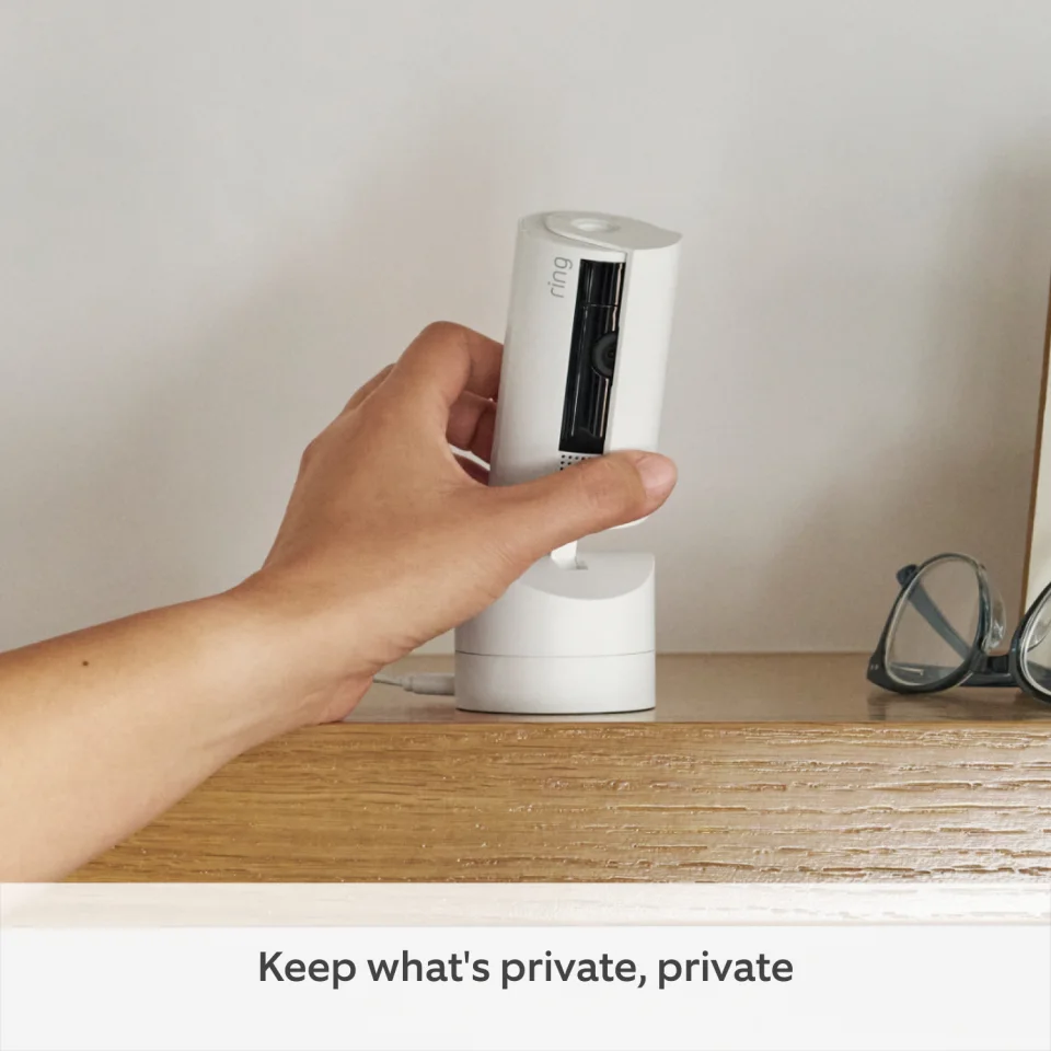Hand sliding the privacy cover on the Ring Pan-Tilt Indoor Cam