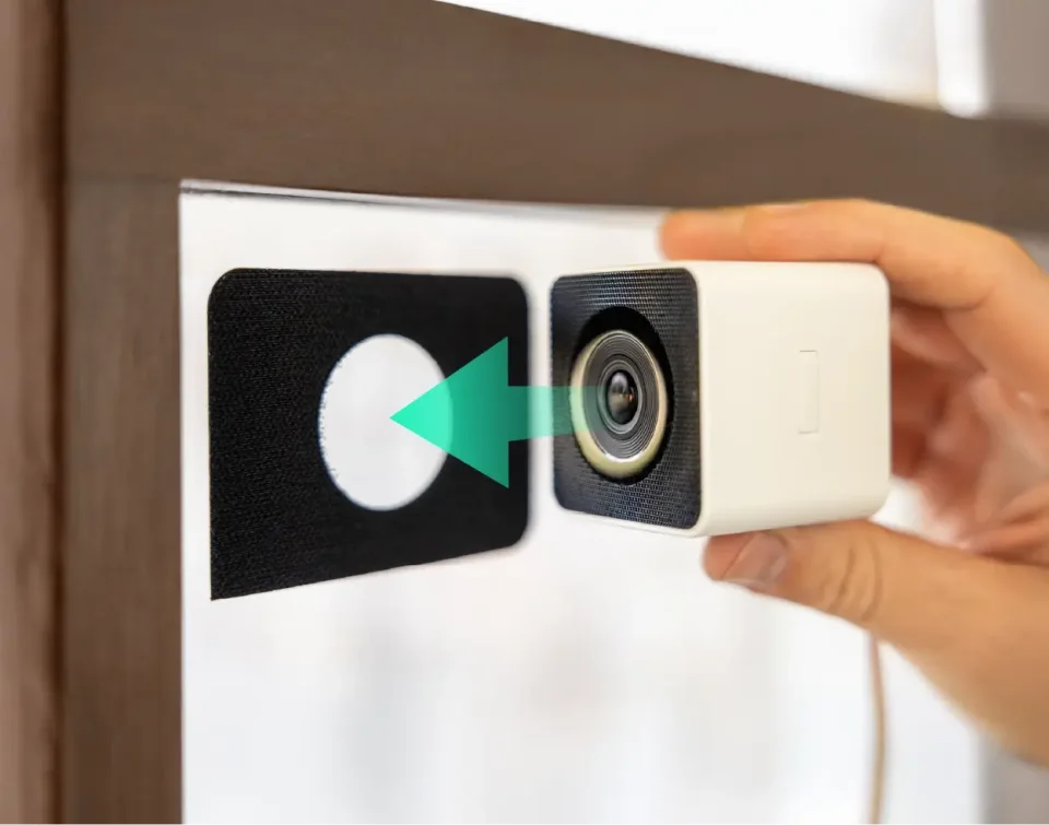 Wyze Window Cam mounted on a window with its peel-and-stick mount