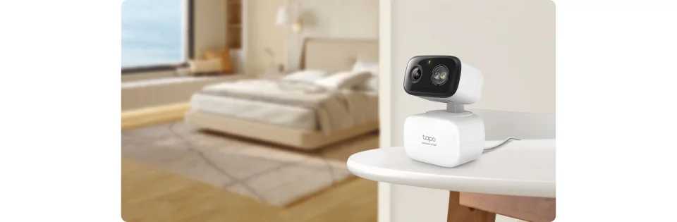 TP-Link Tapo C216 placed on a bedroom nightstand