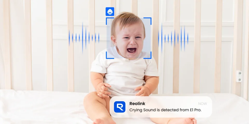 Baby in a crib with a Reolink app notification that a crying sound was detected from the E1 Pro