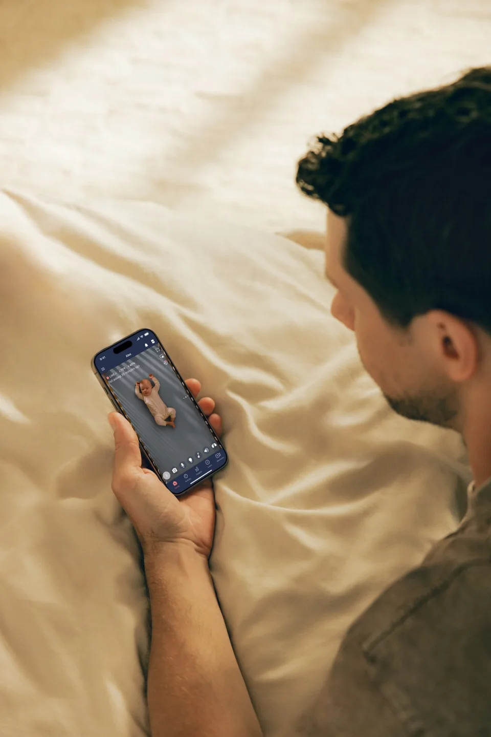 Nanit app on a phone showing a live crib view with temperature and humidity readings