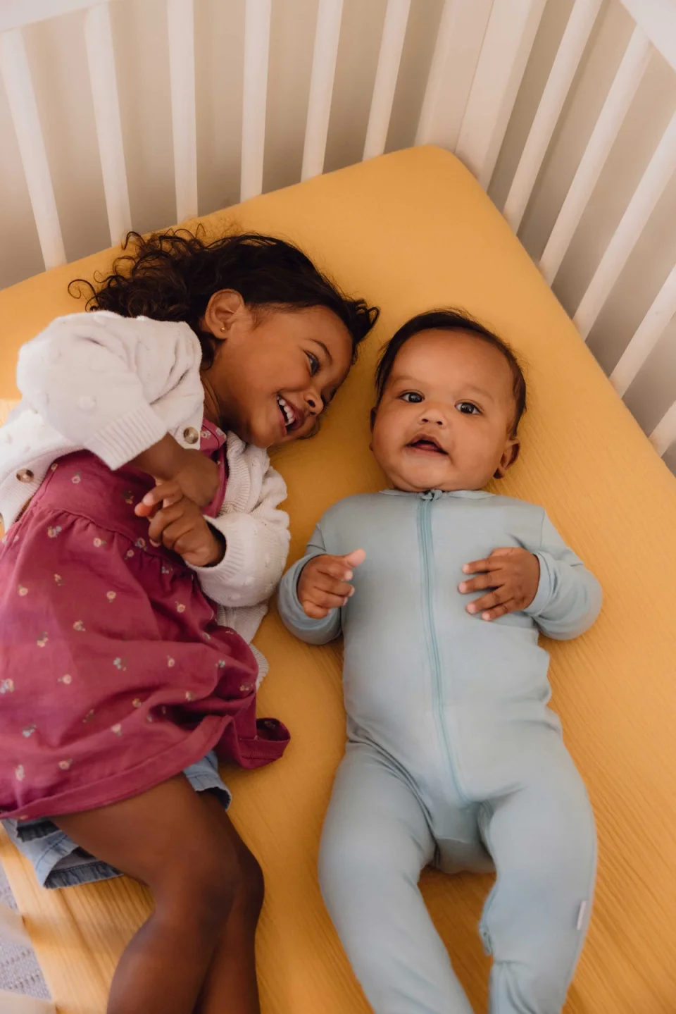 Nanit Pro Camera view of a baby in a crib wearing the patterned Breathing Band