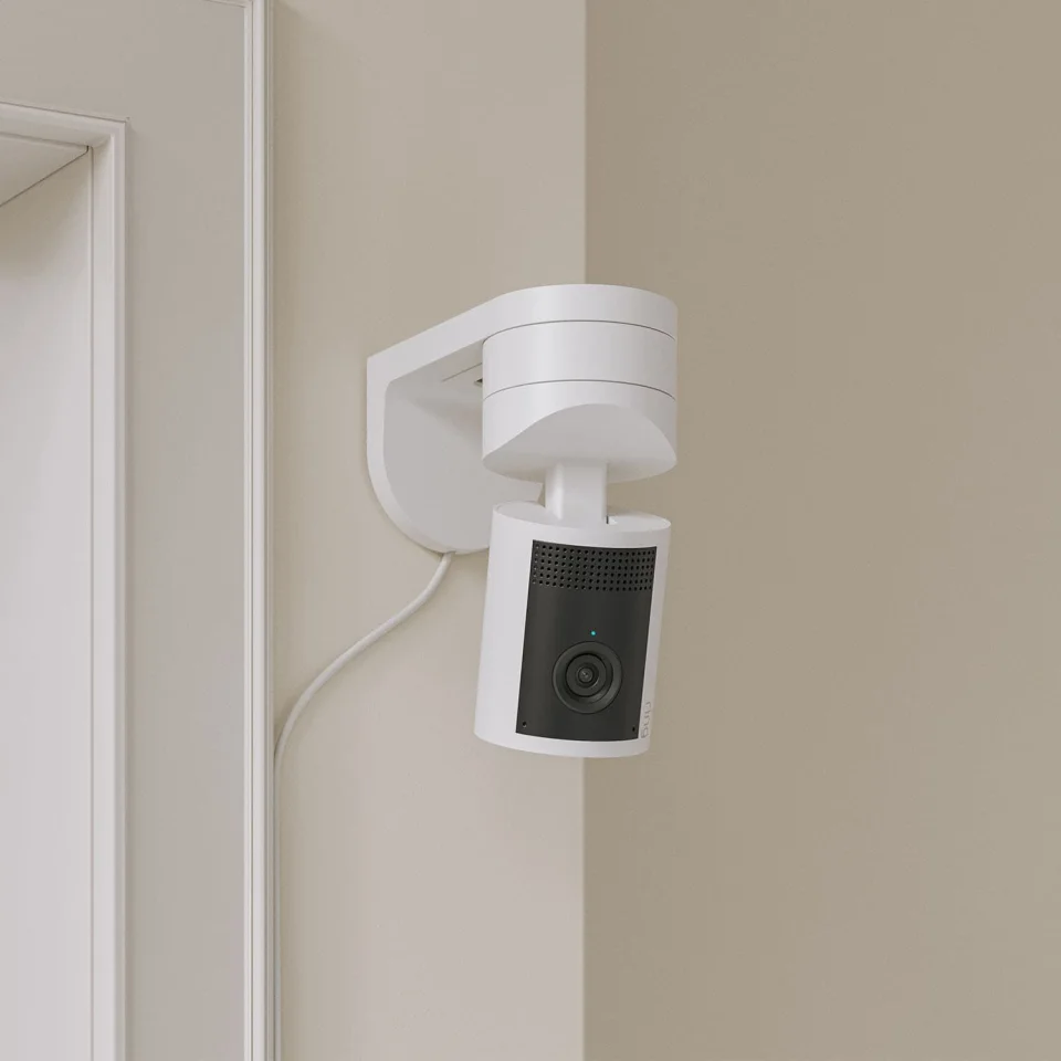 Ring Pan-Tilt Indoor Cam 2K in white wall-mounted upside down in a corner