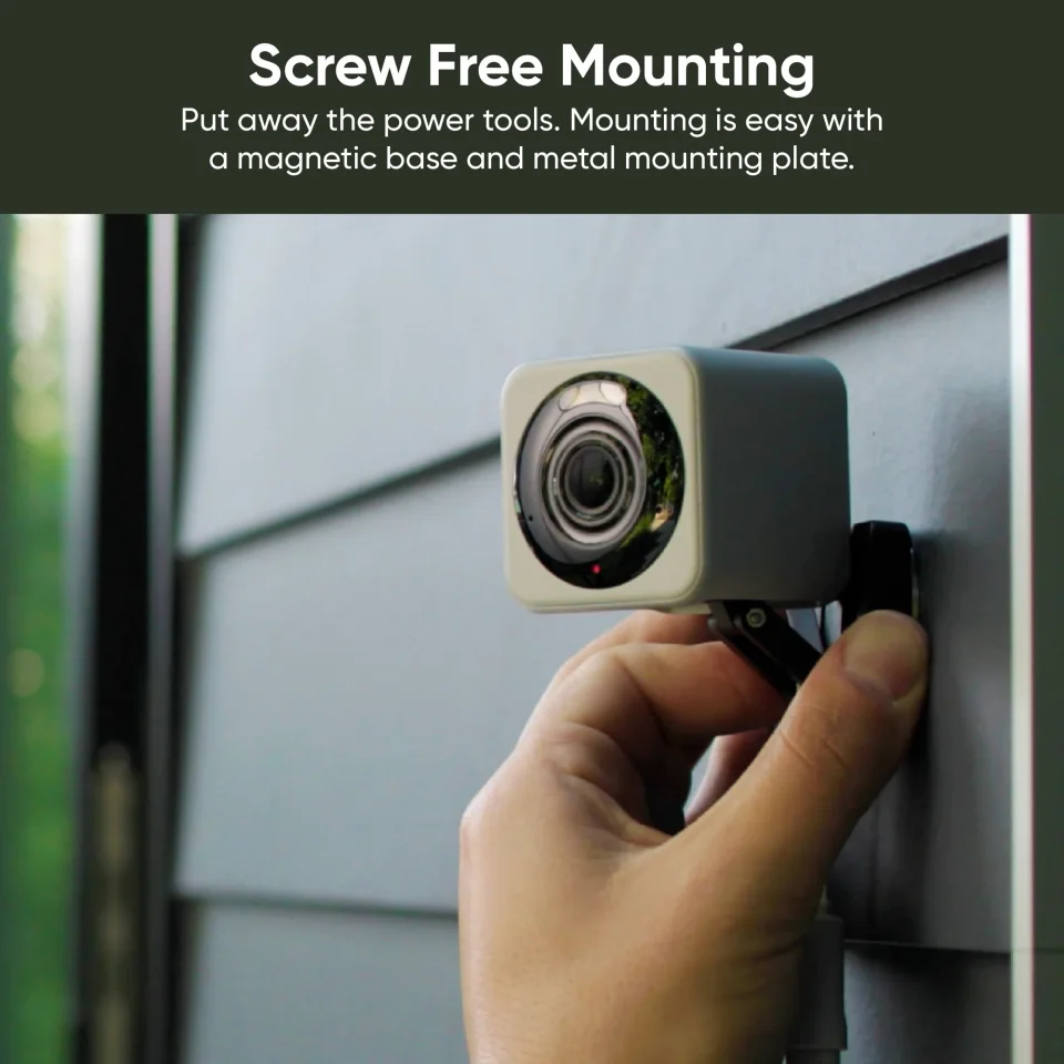 Wyze Cam v4 in grey being fitted to its magnetic wall mount outdoors