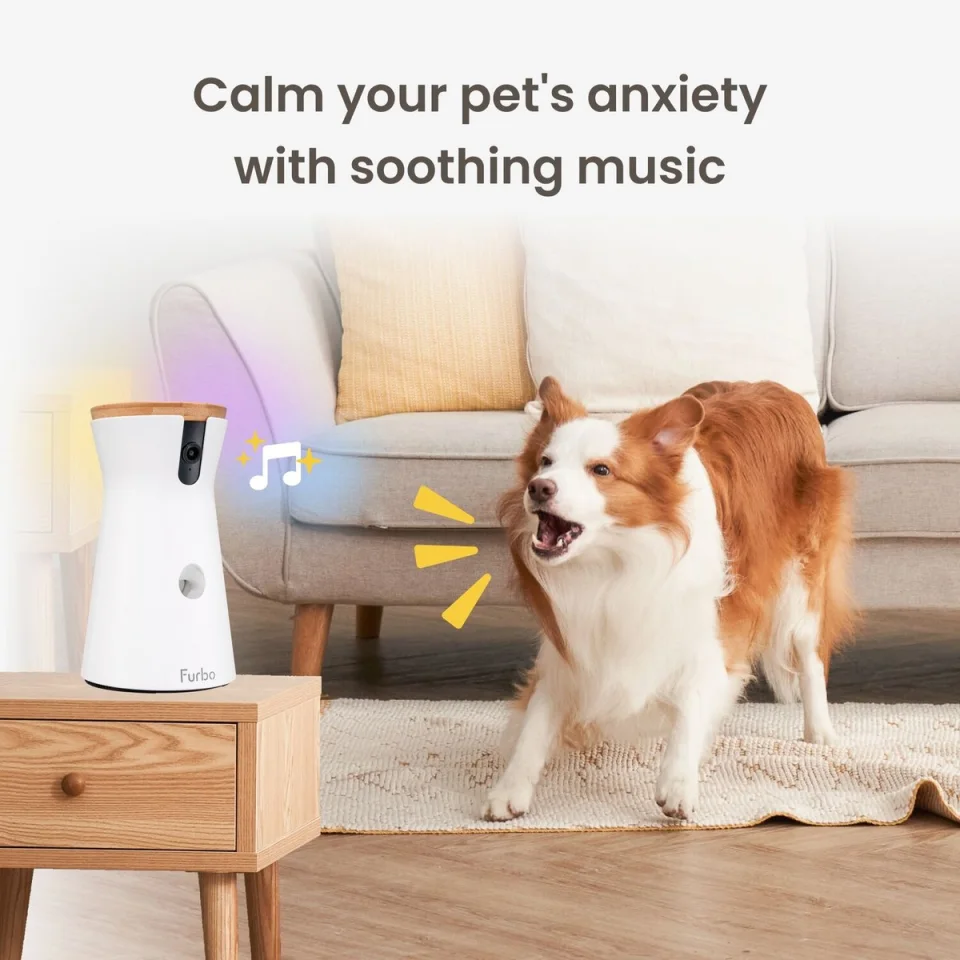 Furbo 360 Dog Camera with bamboo wood cover on a side table next to a barking dog in a living room